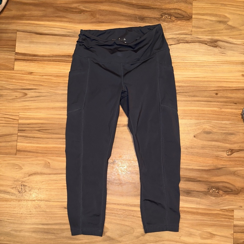 Capris leggings with pockets. Gray in color. Medium in size.